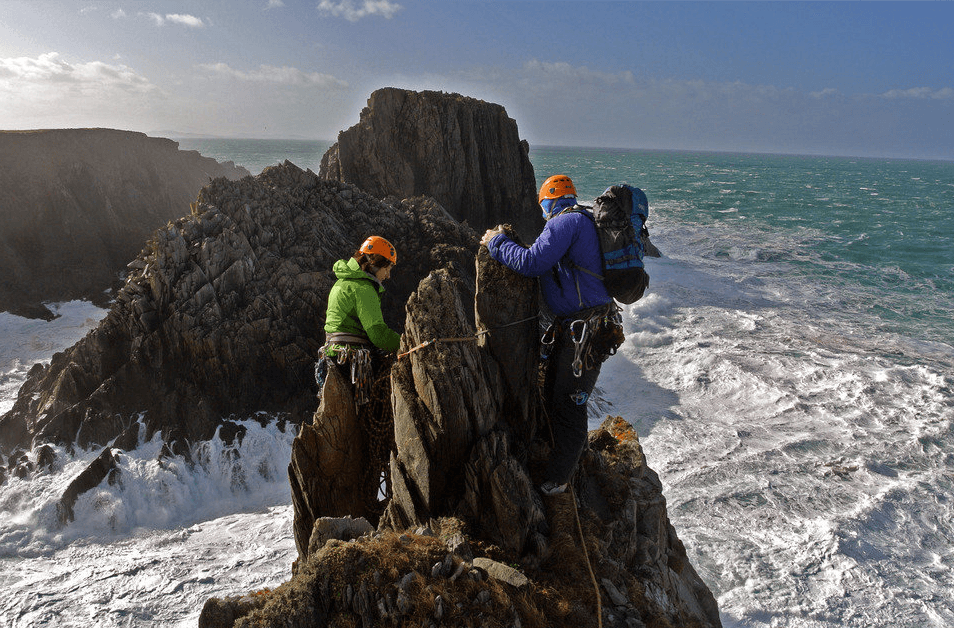 Climbing on a Giant Rock Near the Island