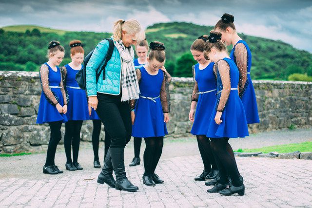 a woman teaching how to walk to irish girls