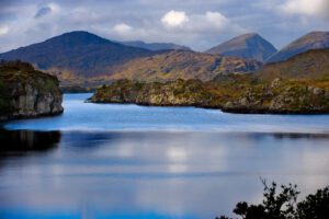 A long shot of the killarney lake and mountains